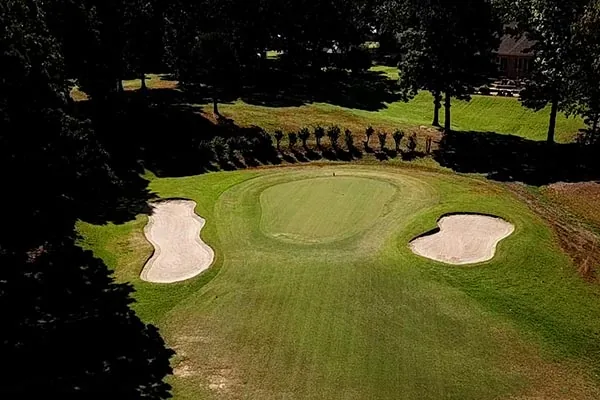 Aerial view of a Back Acres green framed by two sand bunkers