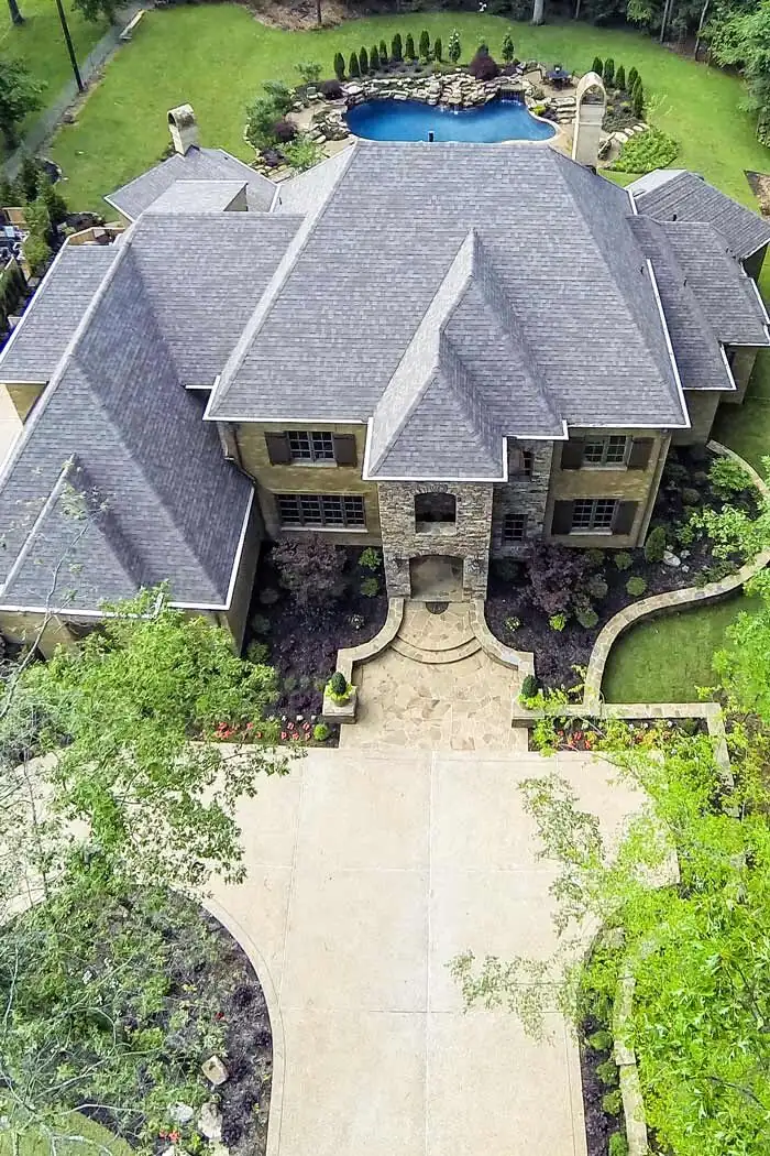 Aerial drone photo of a home and pool landscaped by Camp Creek