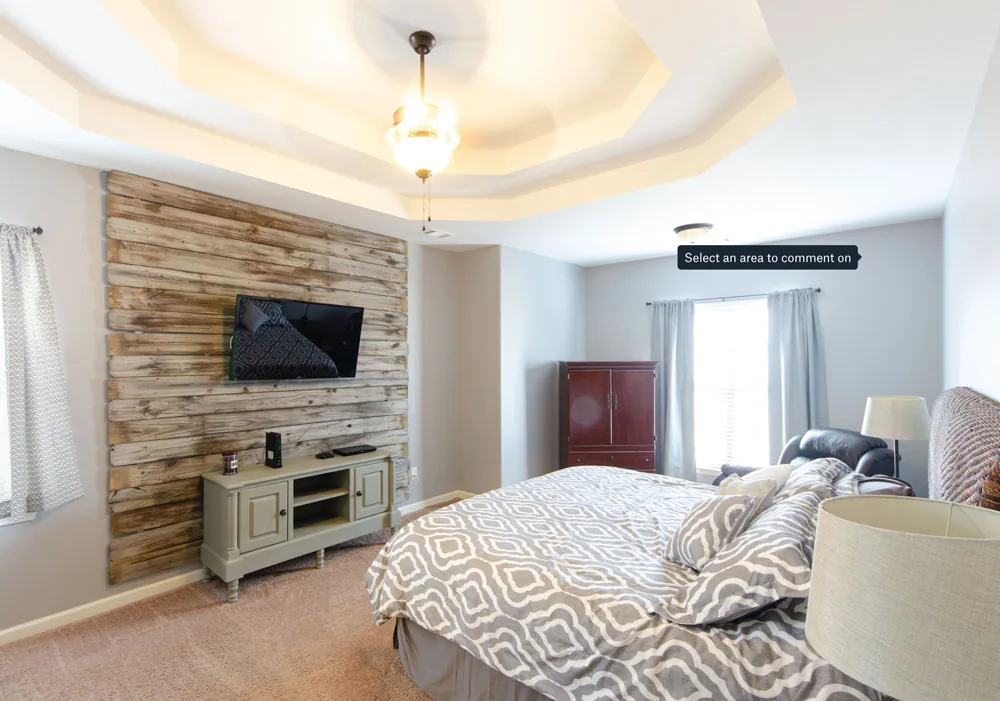 Primary bedroom with a reclaimed wood accent wall