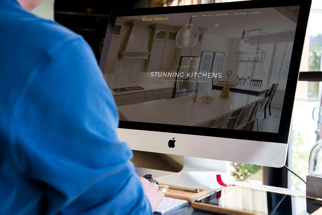 Classic Homes website reading Stunning Kitchens on an iMac