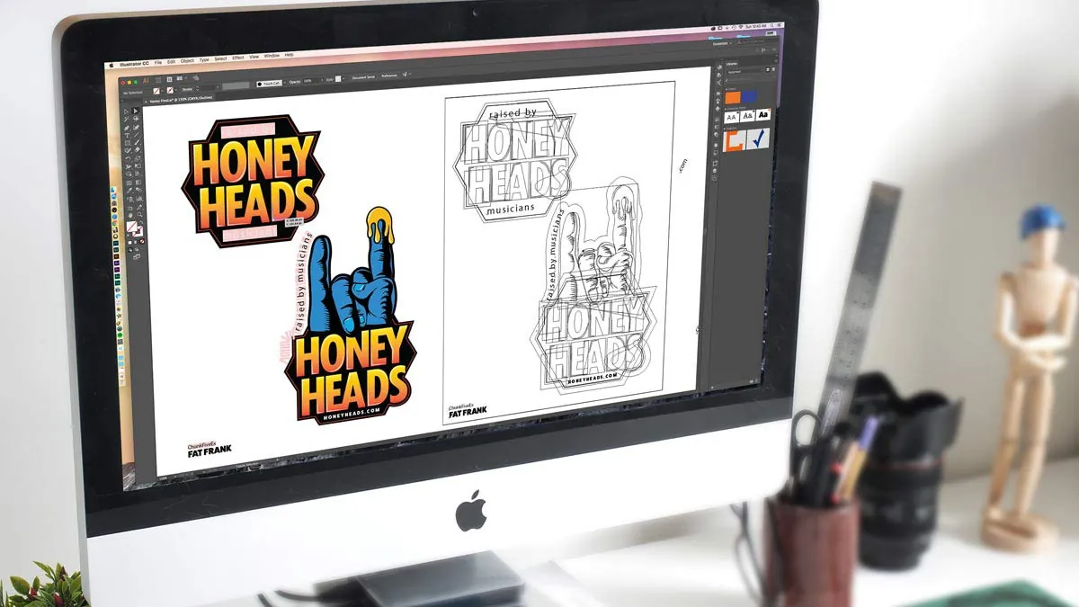 Honey Heads logo being refined in Illustrator on an iMac