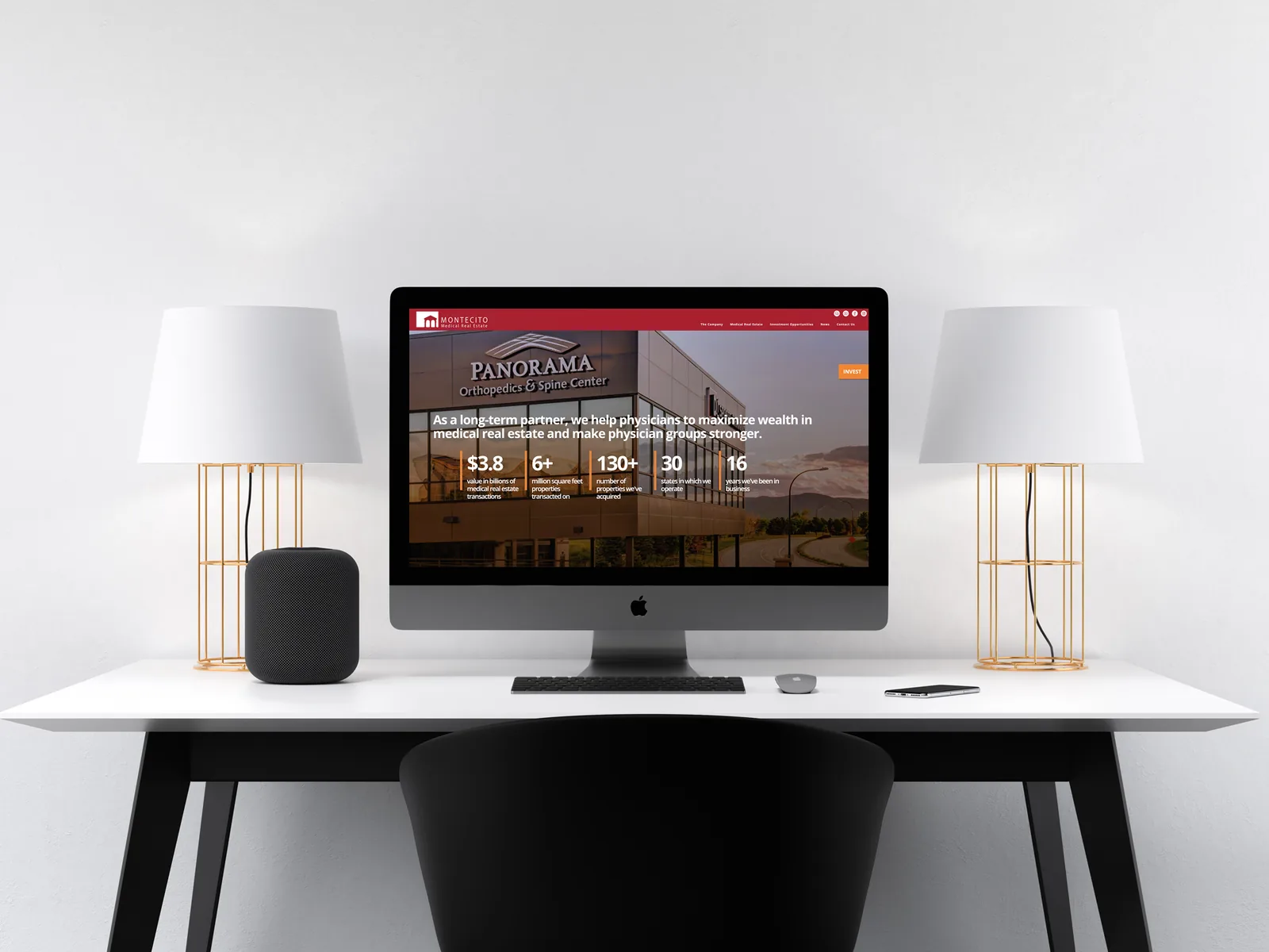 Montecito homepage on an iMac on a white desk between two lamps