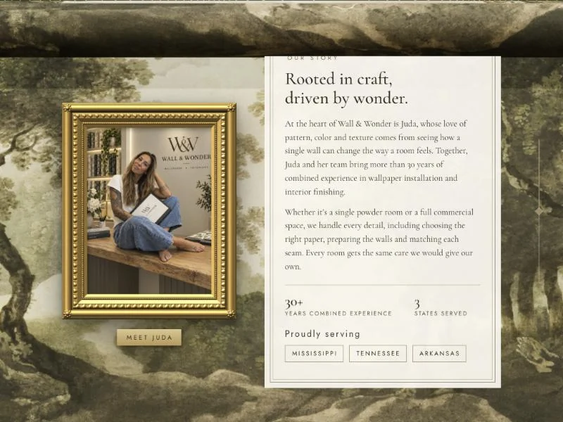 Wall & Wonder's Our Story section with Juda's photo in a gold frame over a forest mural